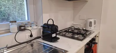a kitchen with a coffee maker on a stove at San Paolo Hideout in Rome