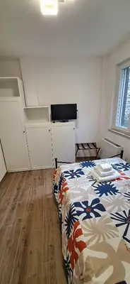 a bedroom with a bed and a television in it at San Paolo Hideout in Rome