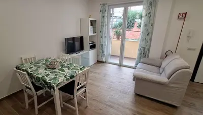 a living room with a table and a couch at San Paolo Hideout in Rome