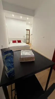 a black table with a bed in a room at Casa Achille - Piazza Bologna in Rome