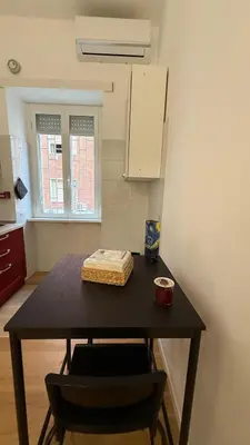 a kitchen with a table in a room at Casa Achille - Piazza Bologna in Rome