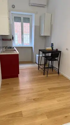 a kitchen with a table and a tableasteryasteryasteryasteryasteryasteryasteryastery at Casa Achille - Piazza Bologna in Rome