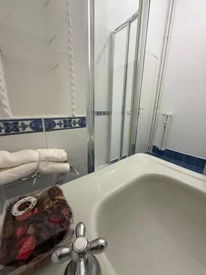 a bathroom with a bath tub with a sink at Casa Achille - Piazza Bologna in Rome