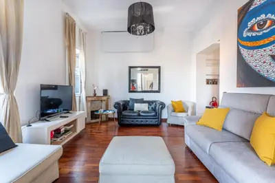 a dining room with a table and chairs in a kitchen at iFlat Spanish Steps Elegant & Spacious Apartment in Rome