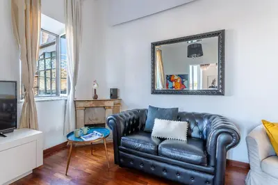 a bedroom with a white bed with towels on it at iFlat Spanish Steps Elegant & Spacious Apartment in Rome