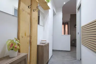 a hallway of a house with a wooden door at Rome - Oasis with Private Garden in Parco Pamphilj in Rome