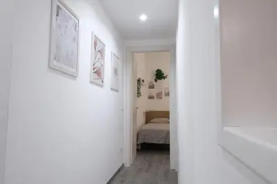 a white hallway with a bed in a bedroom at Rome - Oasis with Private Garden in Parco Pamphilj in Rome