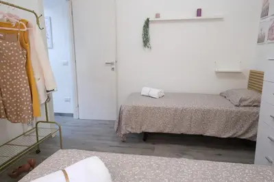 a small room with two beds and a closet at Rome - Oasis with Private Garden in Parco Pamphilj in Rome