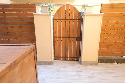 a wooden gate in a room with wooden walls at Rome - Oasis with Private Garden in Parco Pamphilj in Rome