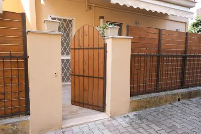 a wooden gate in front of a house at Rome - Oasis with Private Garden in Parco Pamphilj in Rome