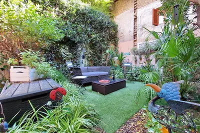 a garden with a couch and a table in a yard at Garden Corner Pigneto apartment Rome in Rome