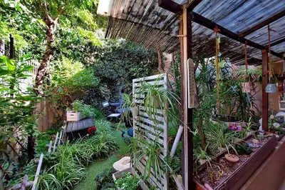 an outdoor garden with plants and a pergola at Garden Corner Pigneto apartment Rome in Rome