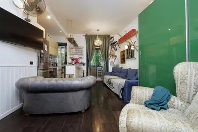 a living room with a couch and a chair and a table at Garden Corner Pigneto apartment Rome in Rome