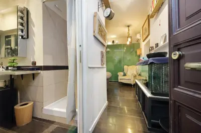 a small room with a hallway with a kitchen and a room with a room at Garden Corner Pigneto apartment Rome in Rome