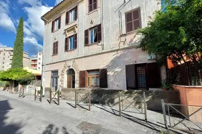 a building with a fence in front of it at Garden Corner Pigneto apartment Rome in Rome