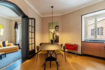 a living room with a table and a couch at Torre Argentina - Charme Holidays in Rome
