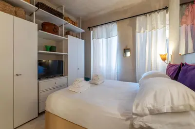 a bedroom with a white bed with towels on it at Torre Argentina - Charme Holidays in Rome
