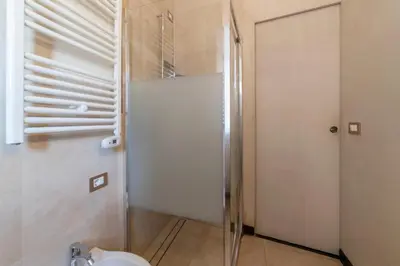 a bathroom with a toilet and a glass door at Torre Argentina - Charme Holidays in Rome