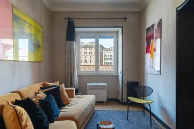 a living room with a couch and a window at Torre Argentina - Charme Holidays in Rome