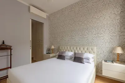 a bedroom with a large white bed with two pillows at Casa Giuliana 91 by Hili in Rome