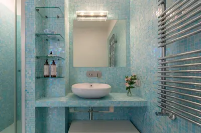 a blue tiled bathroom with a sink and a mirror at Casa Giuliana 91 by Hili in Rome