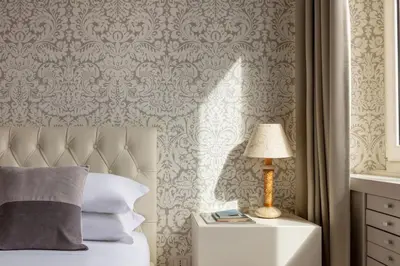 a bedroom with a bed with a lamp on a night stand at Casa Giuliana 91 by Hili in Rome