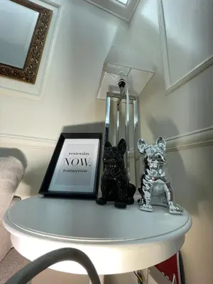 two figurines on a table with a picture and a laptop at The Madame Sofia - A Secret Hotel - Small Boutique Hotel & Apartments in Rome