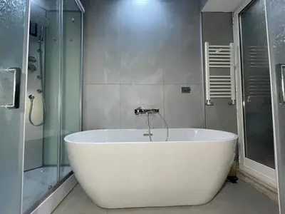 a white bath tub in a bathroom with a shower at The Madame Sofia - A Secret Hotel - Small Boutique Hotel & Apartments in Rome