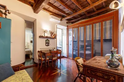 a living room with a table and a dining room at Trastevere Enchanting Apartment in Rome