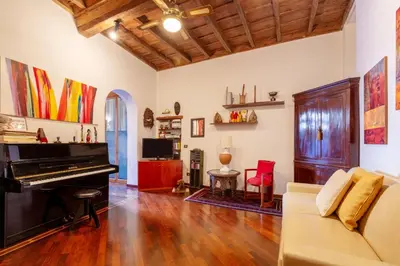 a living room with a piano and a couch at Trastevere Enchanting Apartment in Rome