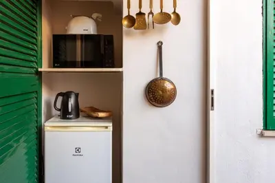 a kitchen with a refrigerator and a microwave at Trastevere Enchanting Apartment in Rome