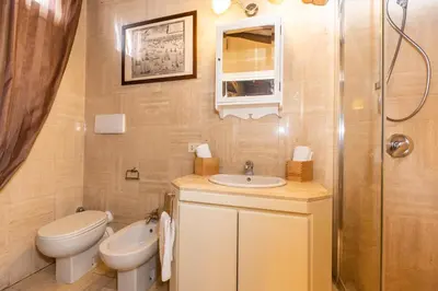 a bathroom with a toilet and a sink and a shower at Pantheon Rondanini Luxury Penthouse in Rome