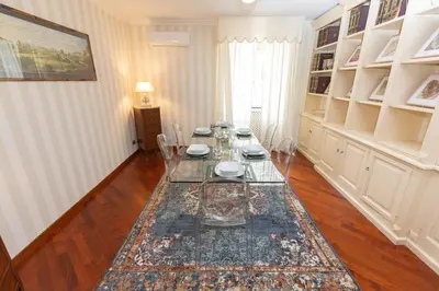 a dining room with a glass table and chairs at Pantheon Rondanini Luxury Penthouse in Rome