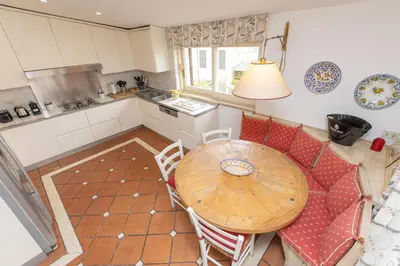 an overhead view of a kitchen with a wooden table and chairs at Pantheon Rondanini Luxury Penthouse in Rome