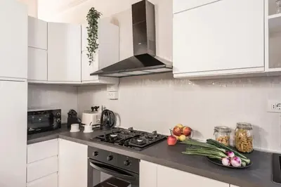 a kitchen with white cabinets and a stove top oven at The Best Rent - Characteristic three-room apartment near Piazza Navona in Rome