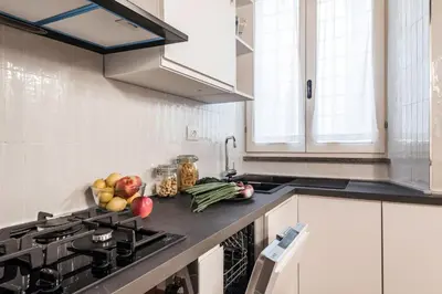 a kitchen with a stove and fruits and vegetables on the counter at The Best Rent - Characteristic three-room apartment near Piazza Navona in Rome