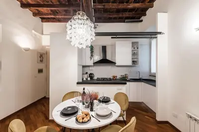 a kitchen and dining room with a table and chairs at The Best Rent - Characteristic three-room apartment near Piazza Navona in Rome