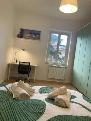 a bedroom with a large bed with two pillows on it at Gemelli Roma House Apartment in Rome