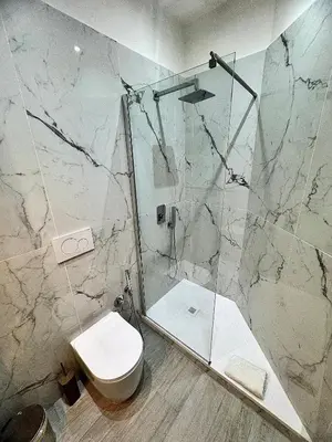 a bathroom with a toilet and a glass shower at Mellini Escape in Rome