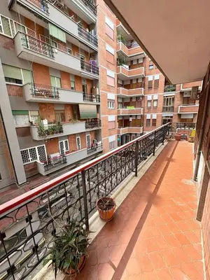 a balcony of an apartment building with potted plants at House of Tribuni - Near metro A in Rome