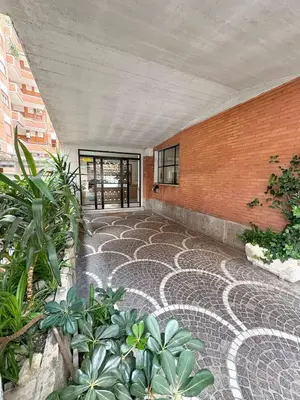 an empty courtyard with plants and a brick wall at House of Tribuni - Near metro A in Rome