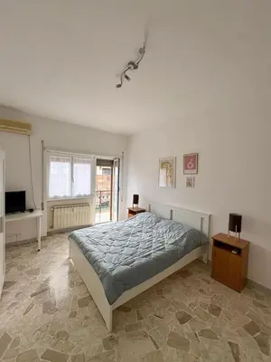 a bedroom with a bed and a television in it at House of Tribuni - Near metro A in Rome
