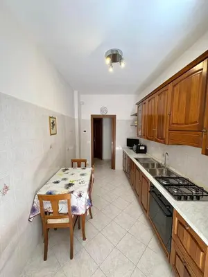 a kitchen with a table and a stove top oven at House of Tribuni - Near metro A in Rome