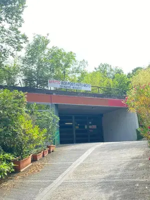 a parking garage with a sign on top of it at The Pilgrim's Court in Rome