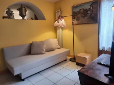 a living room with a couch and a lamp at The Pilgrim's Court in Rome
