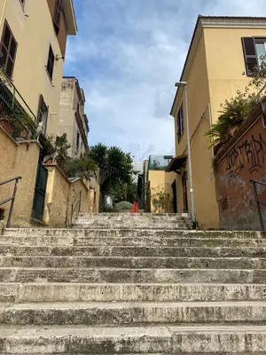 a set of stairs in an alley between two buildings at The Pilgrim's Court in Rome