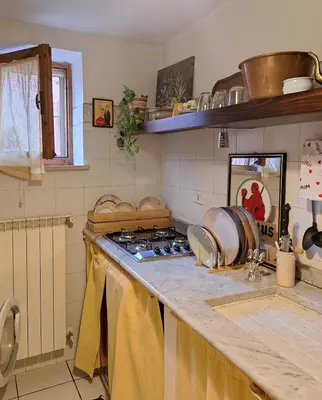 a kitchen with a stove and a counter top at The Pilgrim's Court in Rome