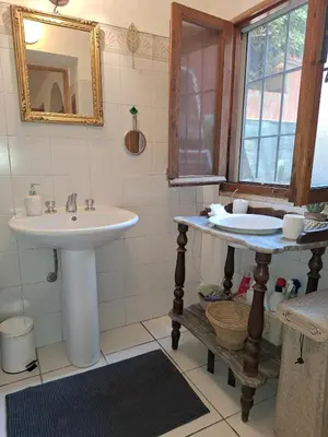 a bathroom with a sink and a mirror at The Pilgrim's Court in Rome