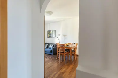 a living room with a table and a couch at Hostly-Roma Clelia Suite-Few Steps from S Giovanni in Rome