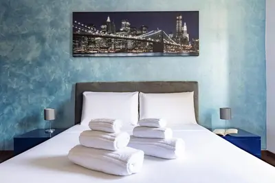 a bedroom with a bed with three pillows on it at Hostly-Roma Clelia Suite-Few Steps from S Giovanni in Rome